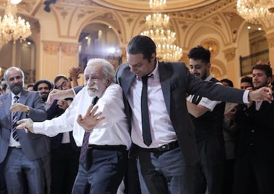 Men dancing in a ballroom.