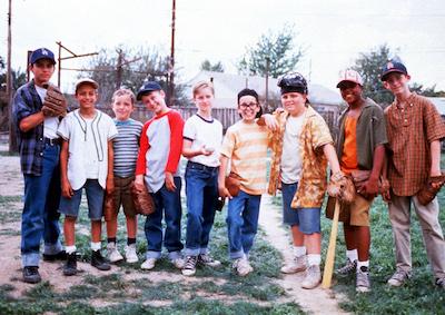 A row of boys wearing baseball gloves.