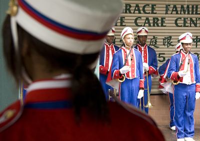 Teens in marching band uniforms.