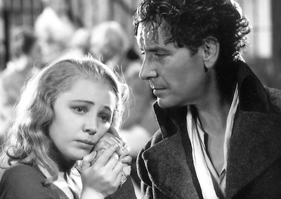 Elizabeth Allan clinging to the hand of Ronald Colman.