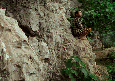 A person sitting on a mountainside.