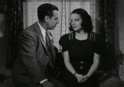 Actors Fernando Soler and Luana de Alcañiz speaking by a window.