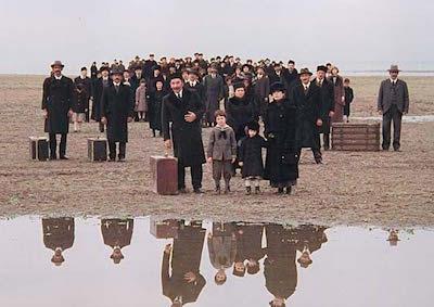 A large crowd of people traveling by foot.