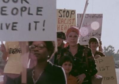 Women holding protest signs.