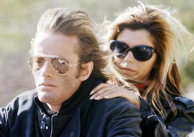 Actors Peter Fonda and Nancy Sinatra wearing sunglasses.