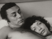 A man and woman lying in bed.