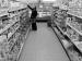 A man shopping in a grocery aisle.