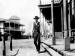 Actor Gary Cooper dressed as a sheriff in a Western town.