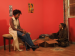 Two women talking in a living room.