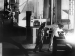 Two people in welding suits in a modernist interior.