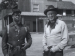 Two men standing outside in an old Western town.