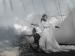 An ethereal image of two women in dresses among clouds.