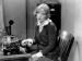 Marion Davies sitting in front of a typewriter.  