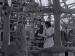 A young man and woman smiling at the Watts Towers.