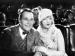 Actors William Haines and Marion Davies sitting in a theater.