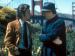 Two men smiling at each other in front of the Golden Gate Bridge.