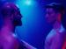 Two shirtless men looking directly at each other.