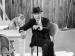 Leonard Cohen seated next to a cat.