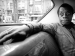 James Baldwin sitting in the back seat of a car.