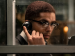 Kingsley Ben-Adir as Malcolm X talking on a phone.