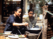 A young girl watching an older woman cook.