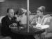 Actors Roland Young, Constance Bennett and Asta the dog sitting around a table.