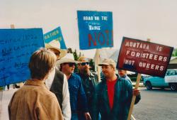 In the Life host Katherine Linton (left) speaks to anti-gay protesters in Montana. 1995.